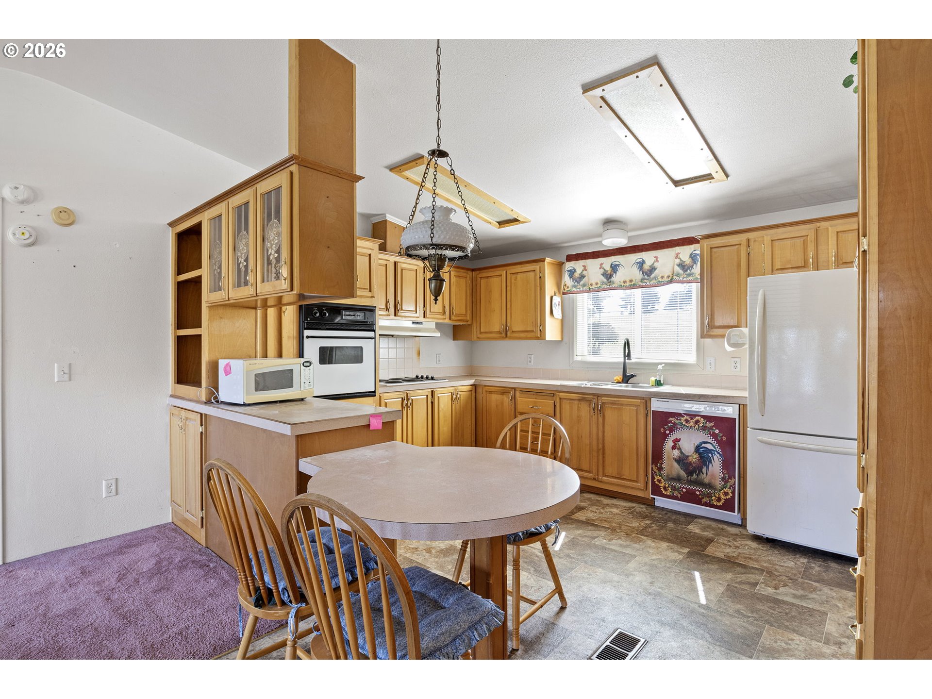 500 Elm Street Yoncalla, OR 97499 - Photo 22 of 48 a kitchen with stainless steel appliances granite countertop a stove a sink dishwasher and a refrigerator with wooden floor