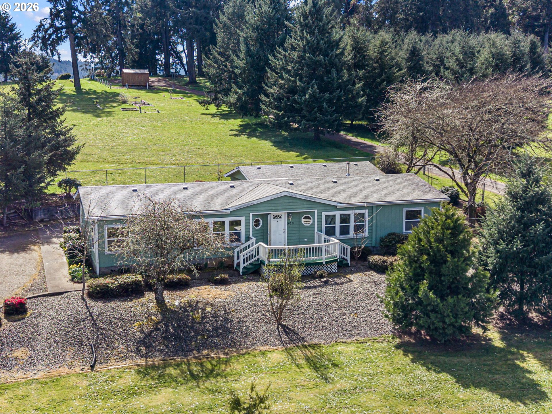500 Elm Street Yoncalla, OR 97499 - Photo 4 of 48 a aerial view of a house with swimming pool and large trees