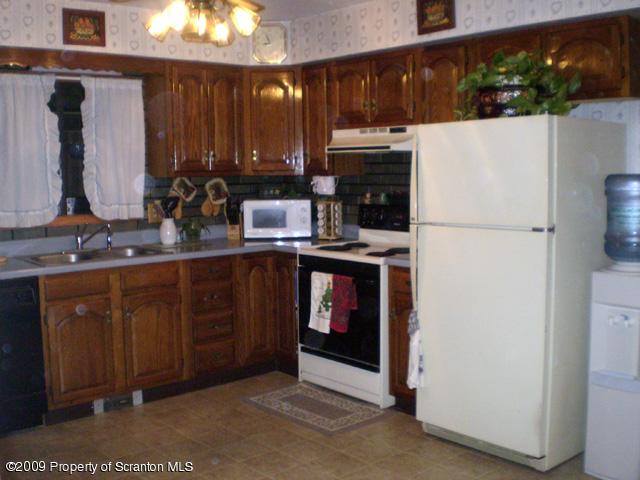 3772 Quarry Road Nicholson, PA 18446 - Photo 4 of 16 a kitchen with stainless steel appliances granite countertop a refrigerator a stove and a sink
