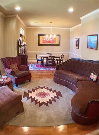 a living room with furniture and a ceiling fan