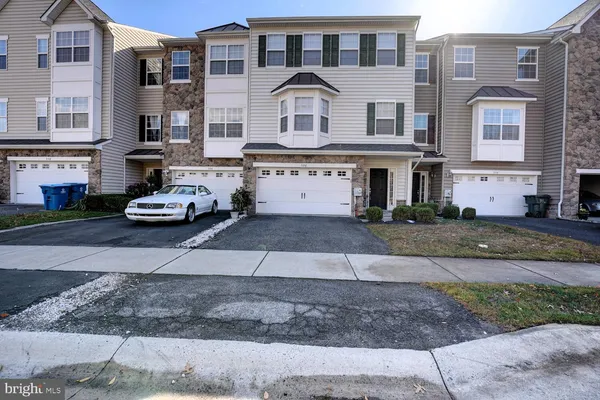 a front view of a residential apartment building with a yard