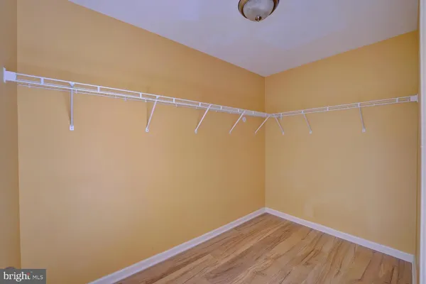 a view of empty room with window and wooden floor