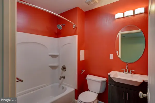 a bathroom with a granite countertop sink toilet mirror and shower