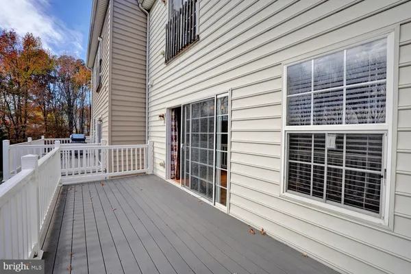 a view of a balcony with wooden floor and fence