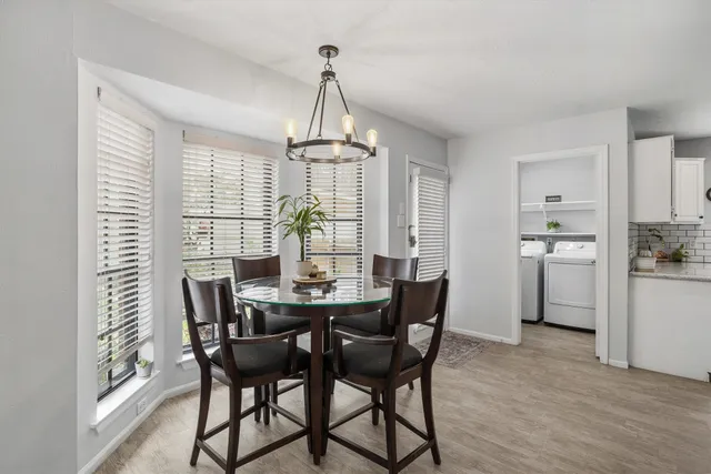a view of a dining room with furniture window and wooden floor