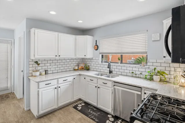 a kitchen with a sink stove and cabinets