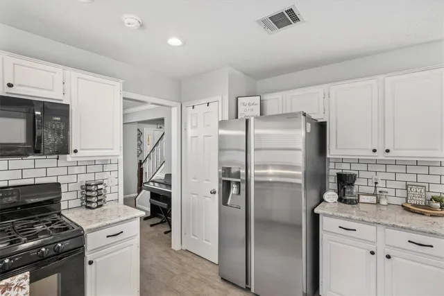 a kitchen with stainless steel appliances a refrigerator stove and microwave