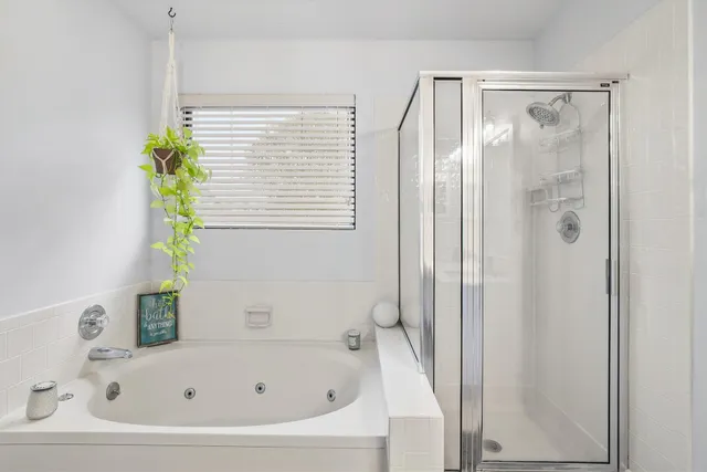 a white bath tub with a shower