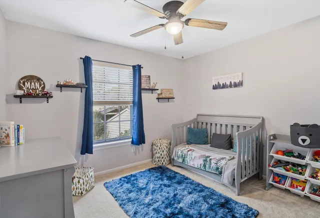 a bedroom with furniture and a window