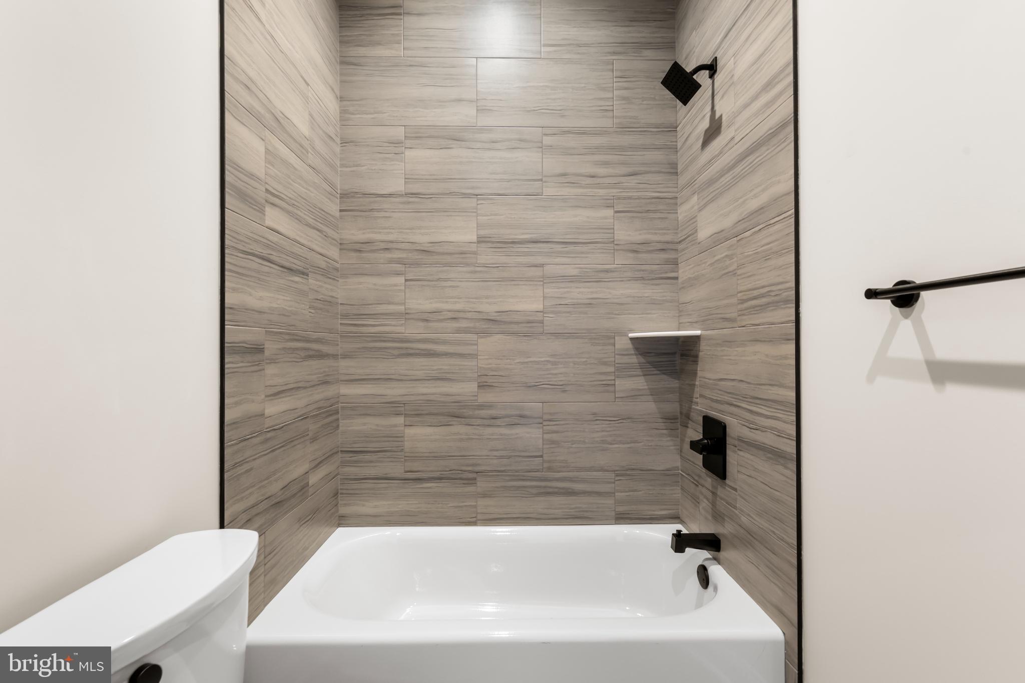 4032 (4050) Marilyn (conshohocken Ave) Drive Philadelphia, PA 19131 - Photo 13 of 42 Sleek modern bathroom with elegant tiles.