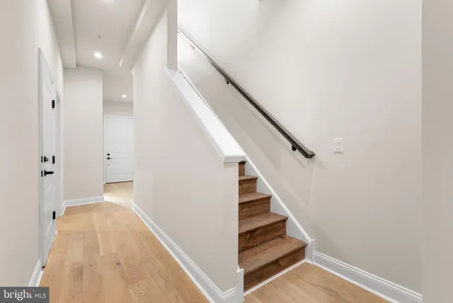 a view of entryway and hall with wooden floor