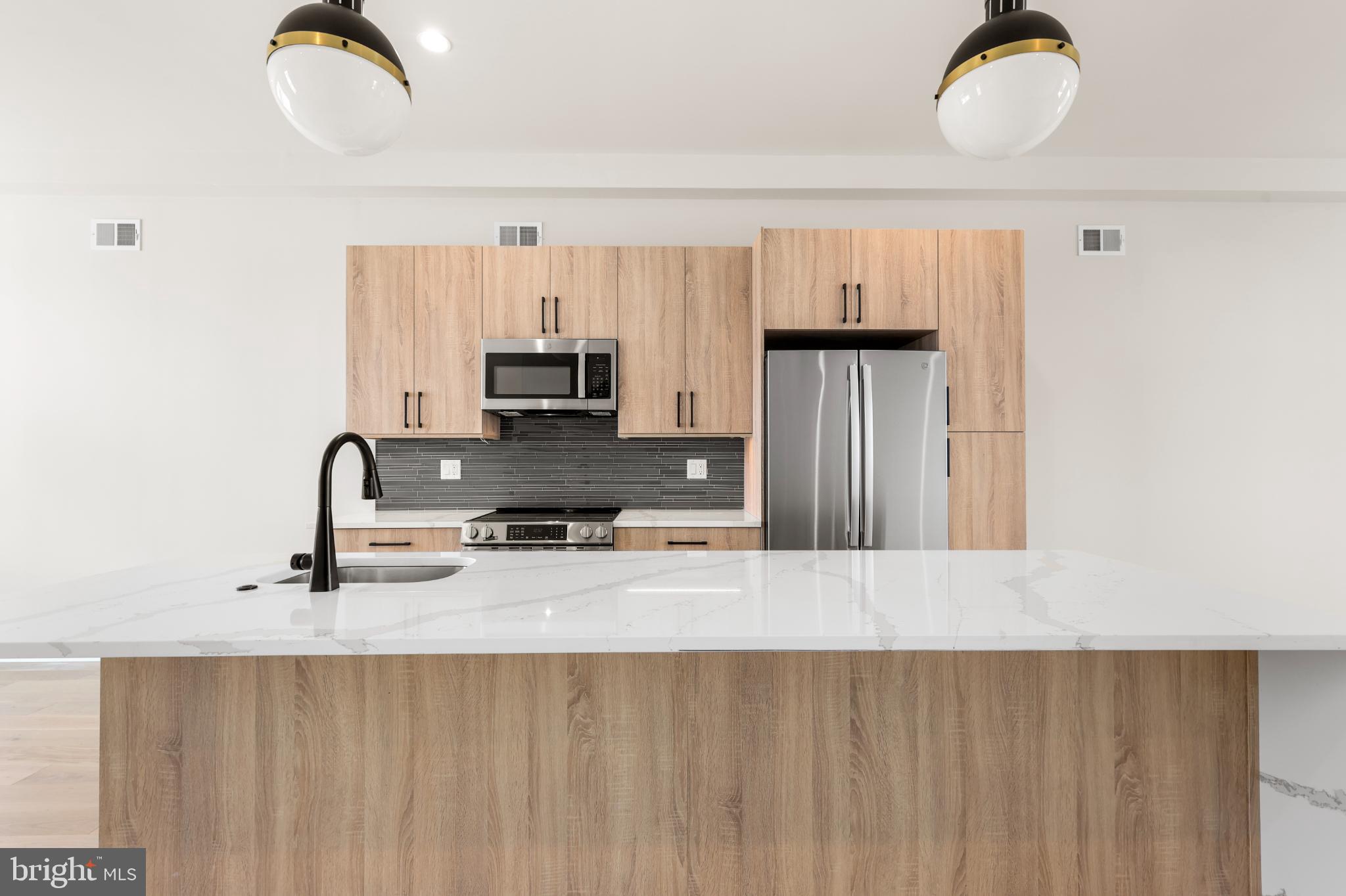 4032 (4050) Marilyn (conshohocken Ave) Drive Philadelphia, PA 19131 - Photo 37 of 42 Sleek modern kitchen with elegant finishes.