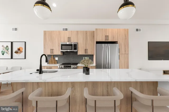 a kitchen with a dining table and chairs