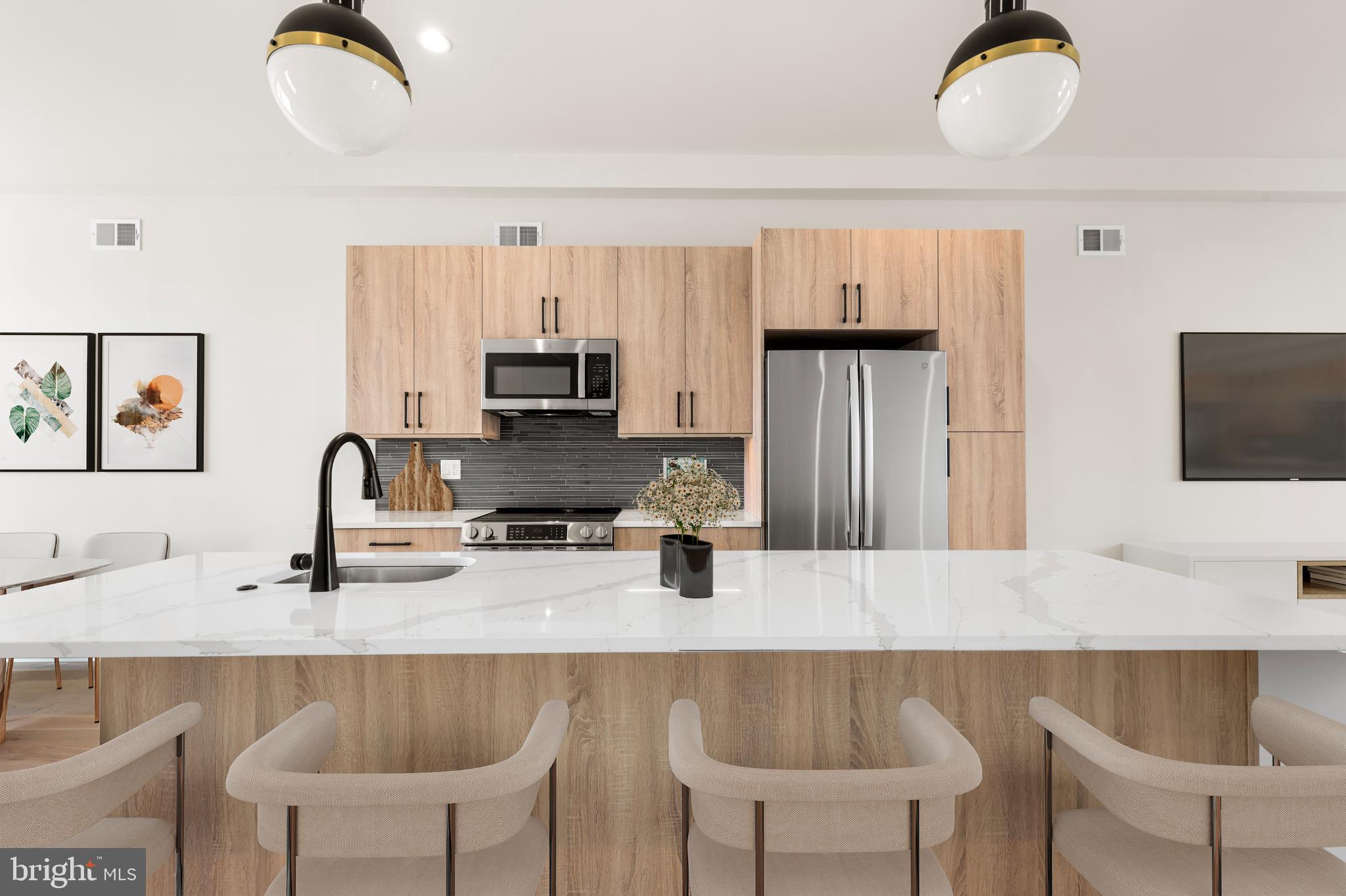 4032 (4050) Marilyn (conshohocken Ave) Drive Philadelphia, PA 19131 - Photo 5 of 42 Sleek modern kitchen with warm wood accents.
