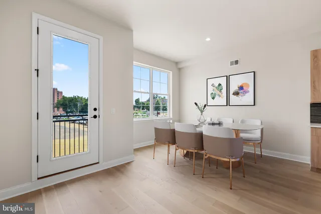 a view of a dining room with furniture window and wooden floor
