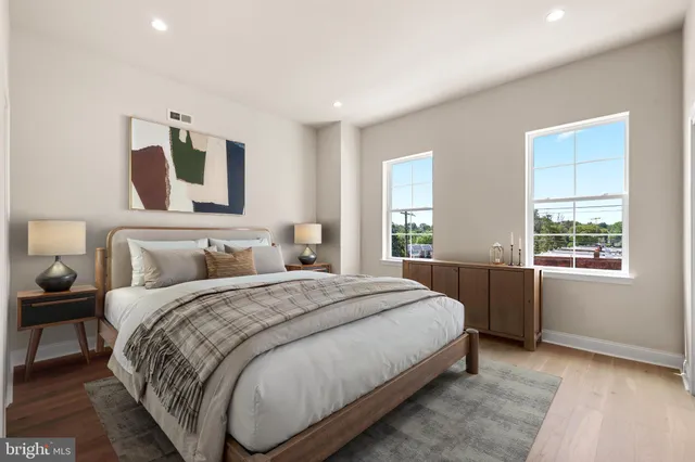 a spacious bedroom with a bed and window