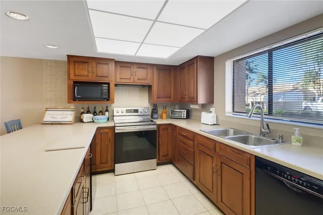 a kitchen with a sink a stove top oven and cabinets
