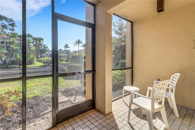 a view of a room with a large window and chair