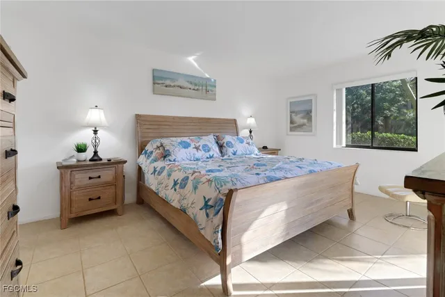 a bedroom with a bed and windows