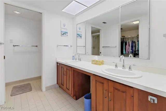 a bathroom with a double vanity sink and a mirror
