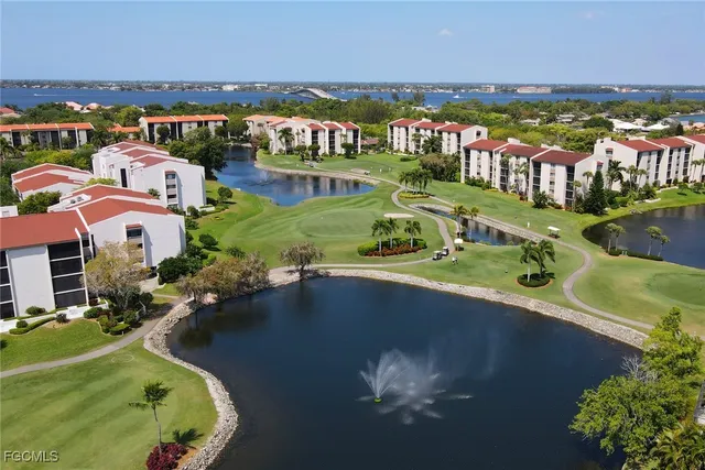an aerial view of residential houses with outdoor space and river view