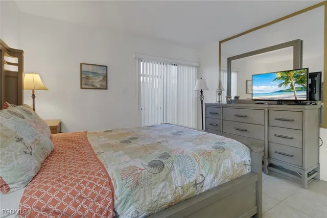 a bedroom with a bed and a flat screen television