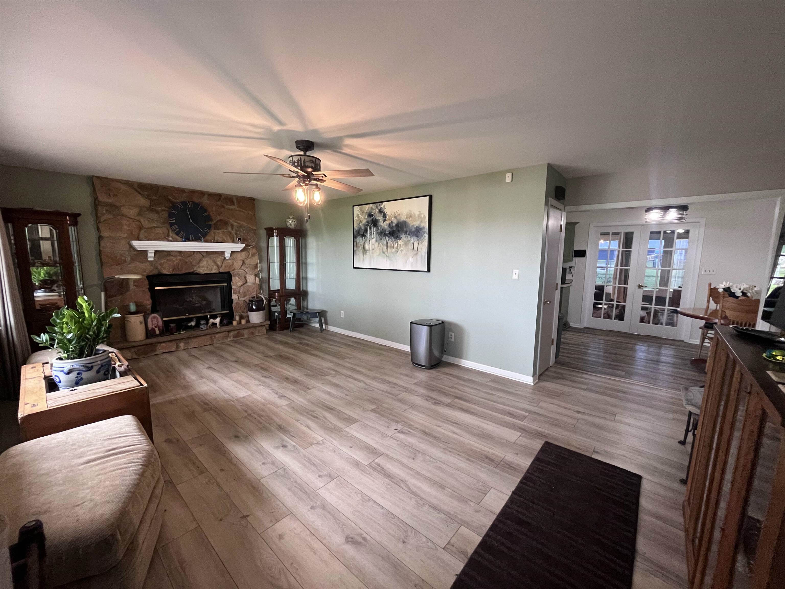 2725 Graham Road Belvidere, IL 61008 - Photo 4 of 31 a view of a livingroom with furniture a dinning room and wooden floor