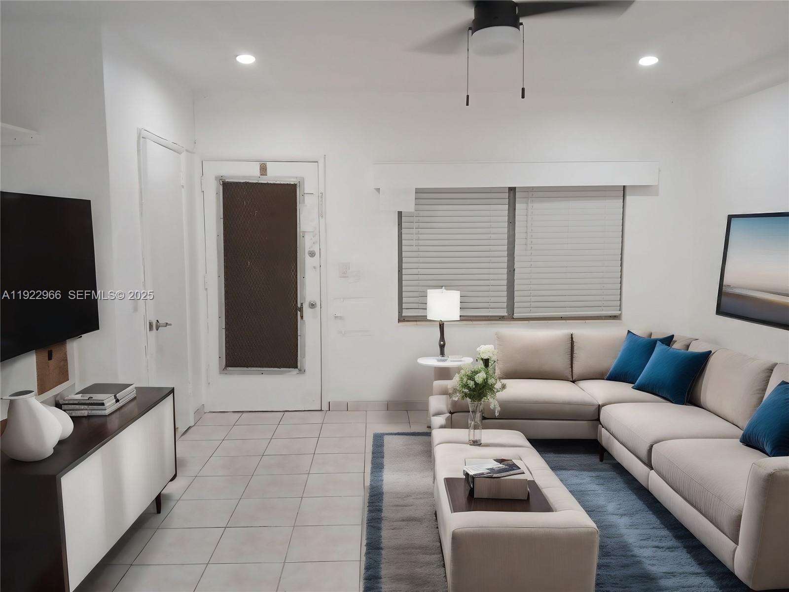 7300 Byron Avenue, Unit 8 Miami Beach, FL 33141 - Photo 1 of 9 a living room with furniture and a flat screen tv