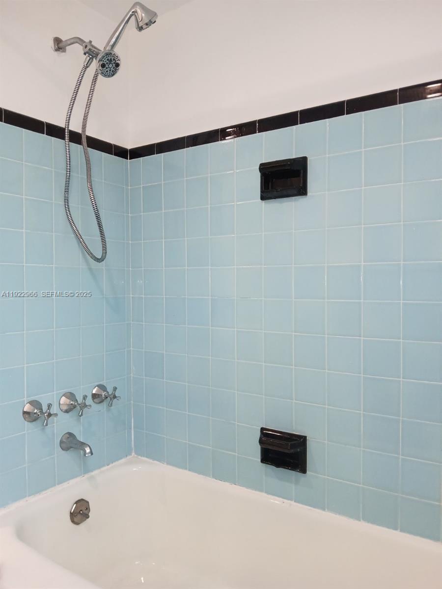 7300 Byron Avenue, Unit 8 Miami Beach, FL 33141 - Photo 4 of 9 a bathroom with a shower and a bathtub