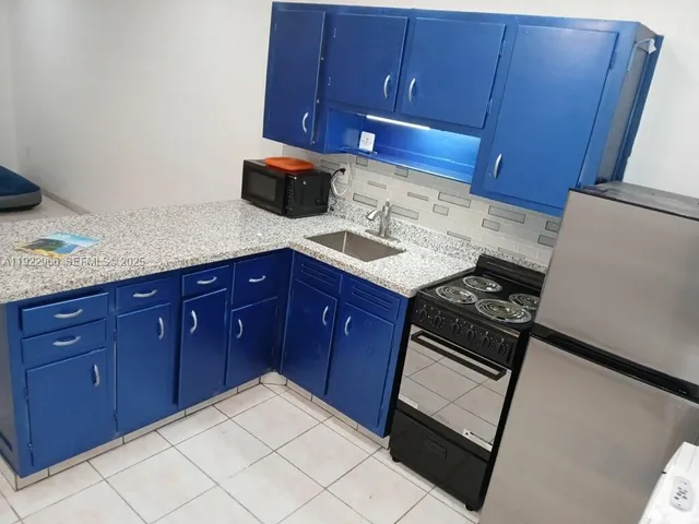 a kitchen with a stove microwave and sink