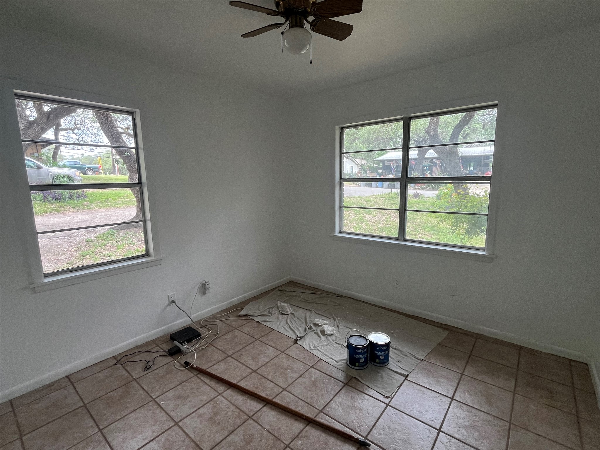 1607 Lightsey Road, Unit A Austin, TX 78704 - Photo 15 of 17 Room featuring two windows, neutral painted walls, and square tile flooring