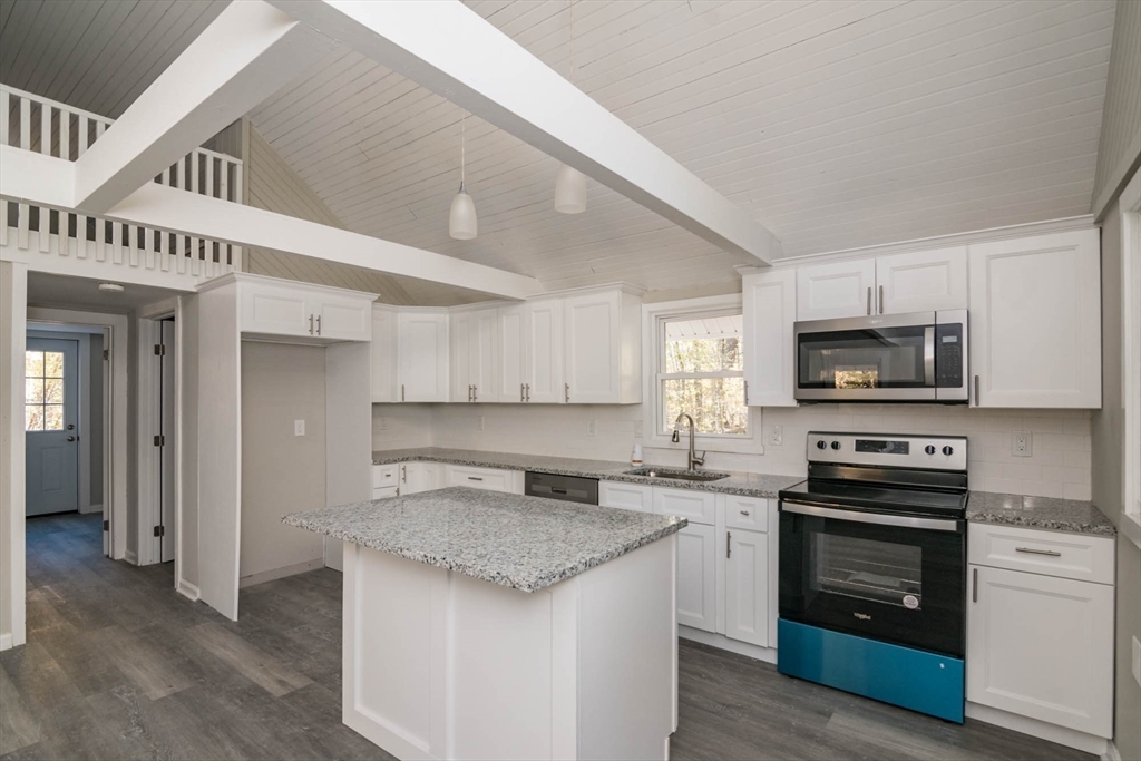 56 Ball Road Goshen, MA 01096 - Photo 13 of 33 a kitchen with granite countertop a stove sink and a microwave