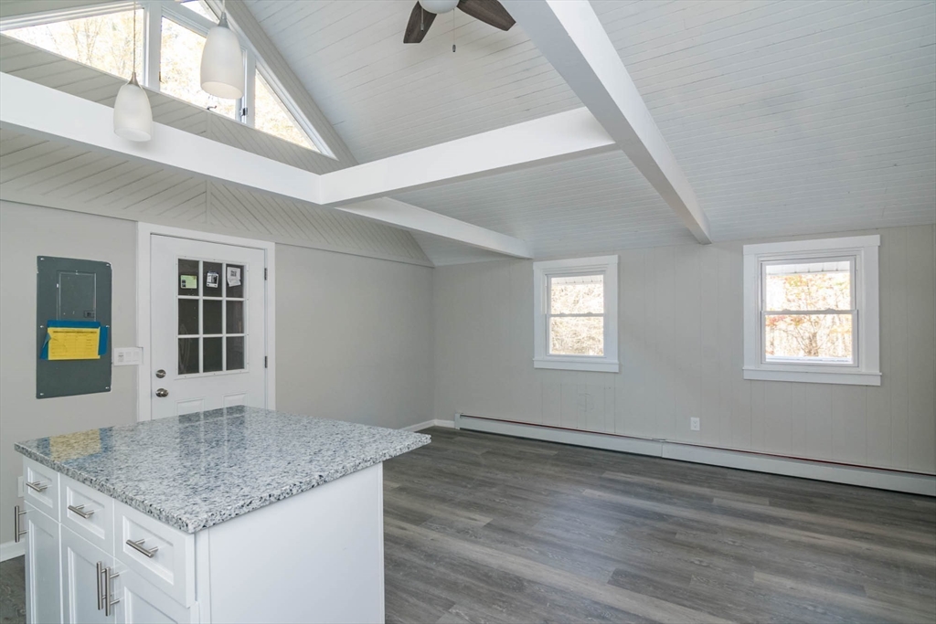 56 Ball Road Goshen, MA 01096 - Photo 18 of 33 a kitchen with a sink granite counter tops and a stove