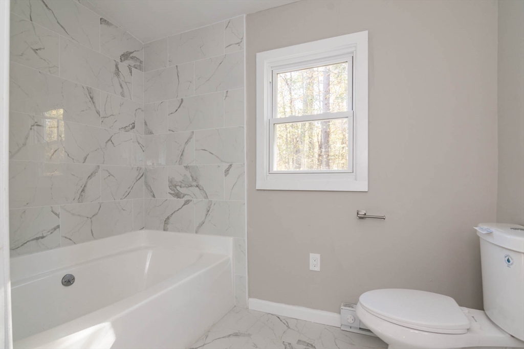 56 Ball Road Goshen, MA 01096 - Photo 28 of 33 a white bath tub sitting next to a toilet