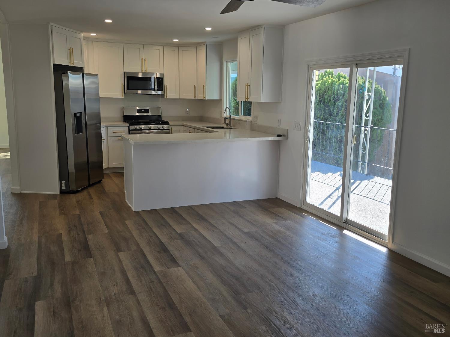 468 Colonial Park Drive Santa Rosa, CA 95403 - Photo 11 of 26 a kitchen with stainless steel appliances a refrigerator sink and wooden floor