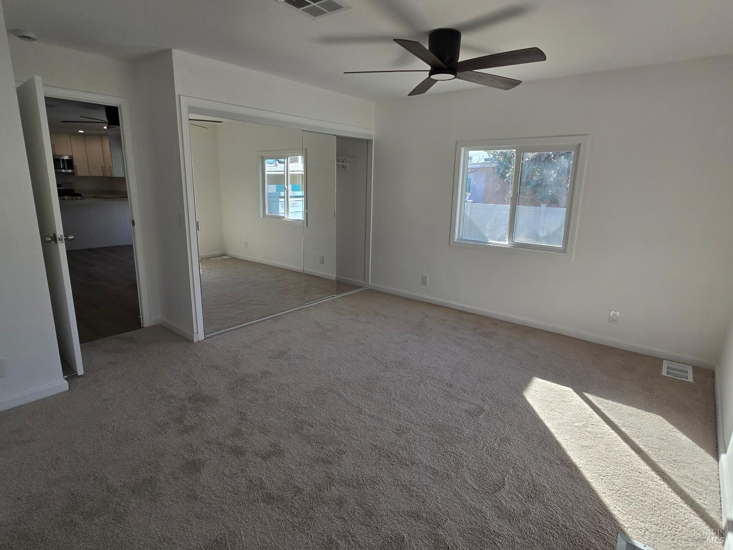 468 Colonial Park Drive Santa Rosa, CA 95403 - Photo 18 of 26 en empty room with windows and ceiling fan