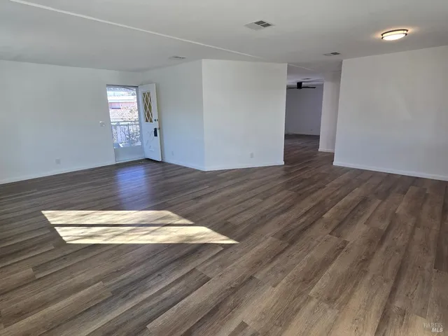 a view of an empty room and wooden floor