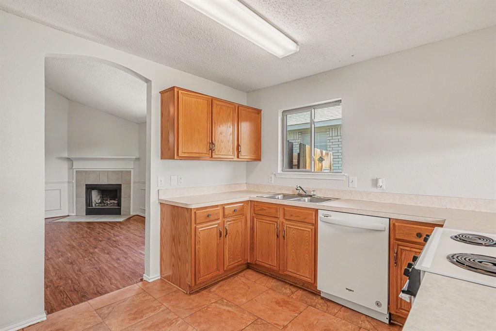 2541 Rivers Edge Drive Fort Worth, TX 76118 - Photo 7 of 31 a kitchen with a sink cabinets appliances and a window