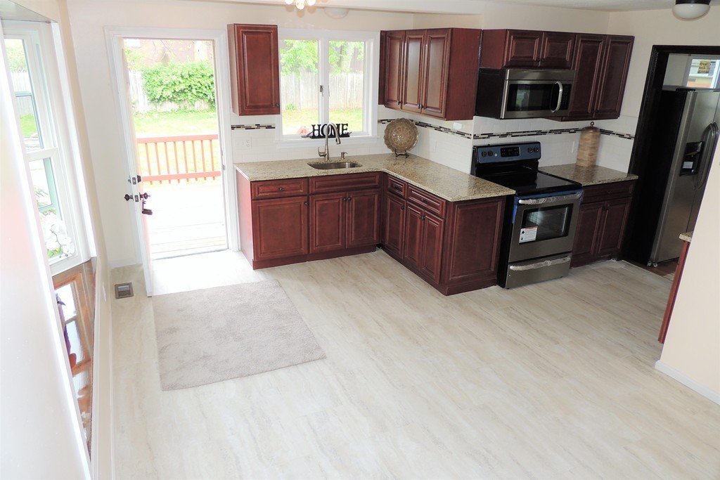 29 Dwight Road Springfield, MA 01108 - Photo 5 of 25 a kitchen with stainless steel appliances granite countertop a refrigerator sink and microwave