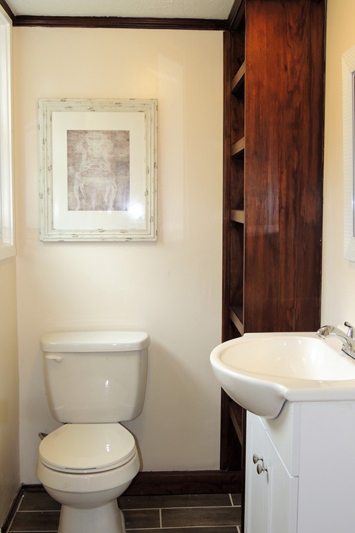 29 Dwight Road Springfield, MA 01108 - Photo 8 of 25 a bathroom with a toilet a sink and a mirror