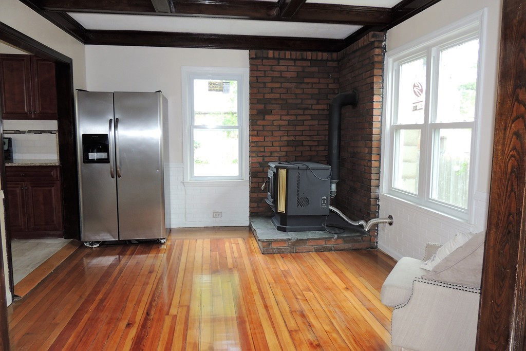 29 Dwight Road Springfield, MA 01108 - Photo 10 of 25 a view of a livingroom with wooden floor and a fireplace