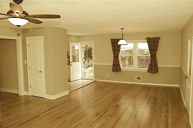 a view of an empty room with glass door