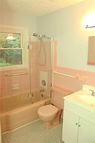 a bathroom with a toilet sink and shower