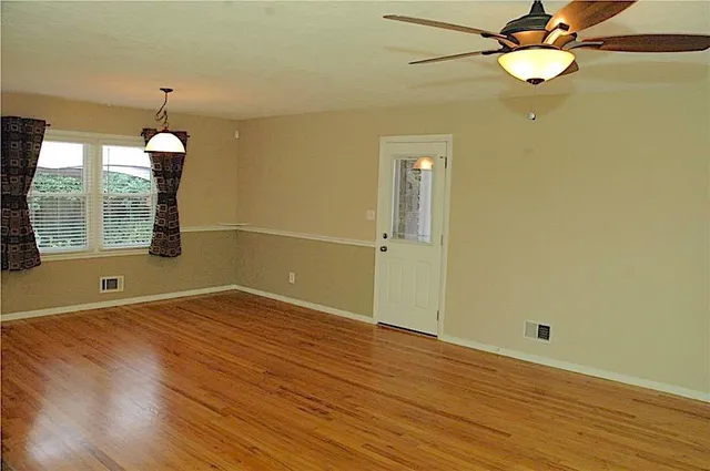 wooden floor in an empty room with a window