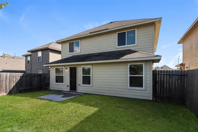 a view of a house with a backyard