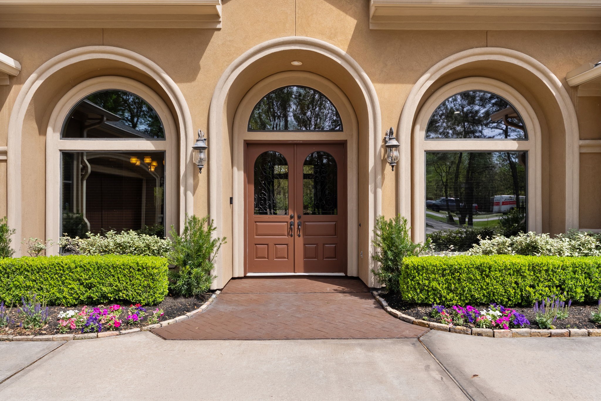 3907 Rayford Road Spring, TX 77386 - Photo 7 of 38 The arched windows and double front doors, along with the herringbone brick front porch, create a warm, welcoming first impression.