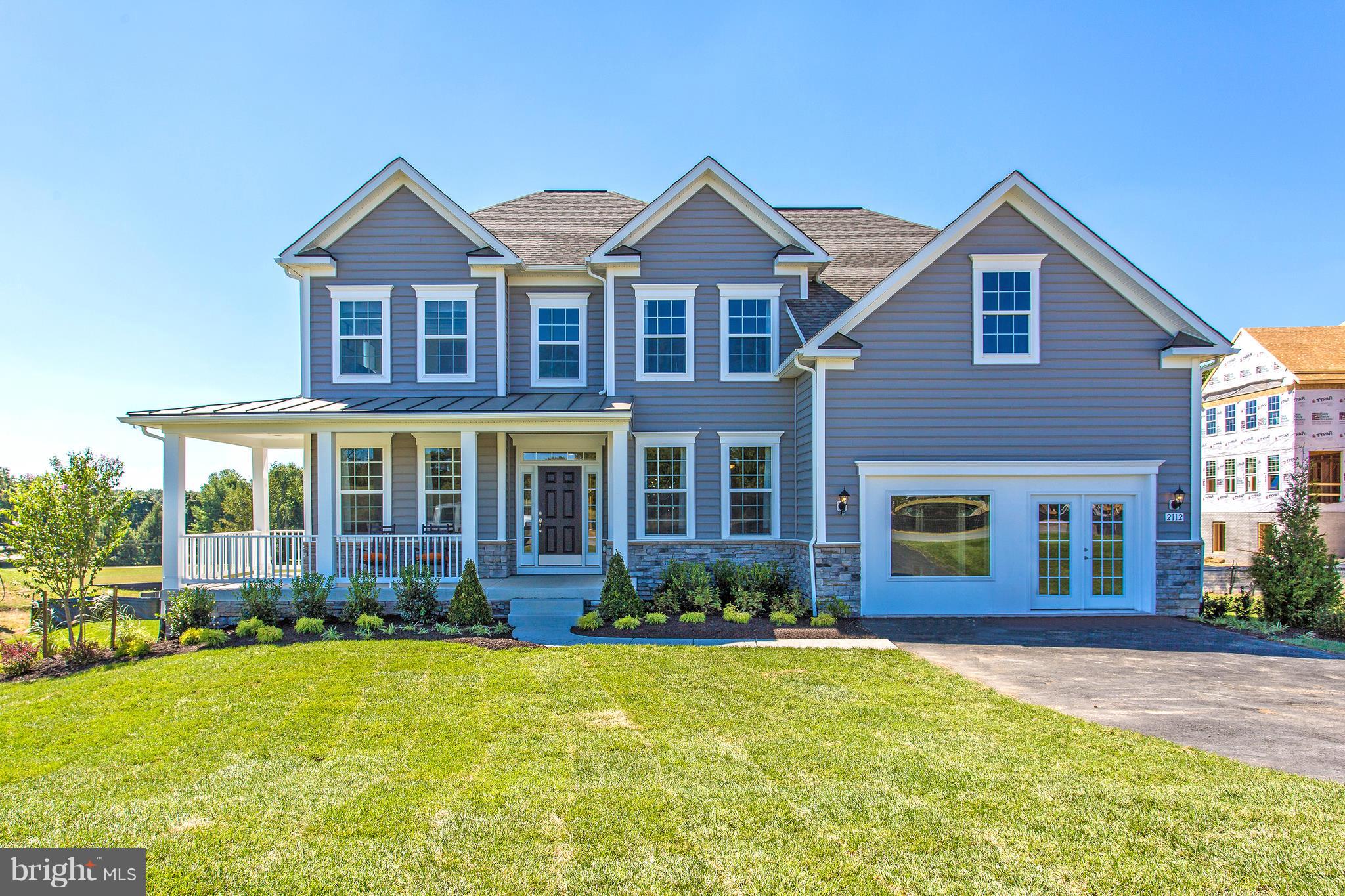 a front view of a house with yard and green space