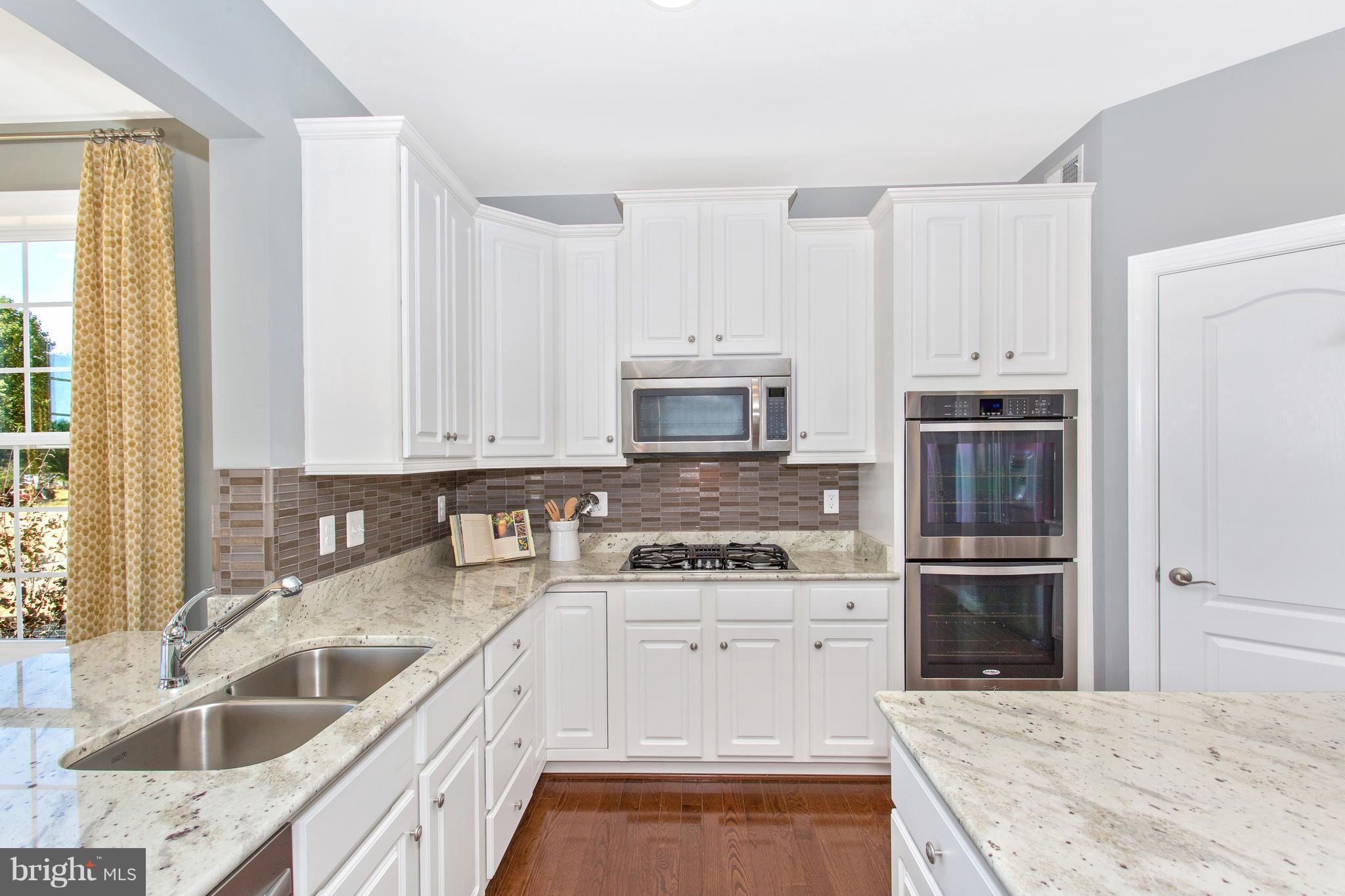 2112 Gable Drive Jessup, MD 20794 - Photo 17 of 27 a kitchen with a sink stove and cabinets