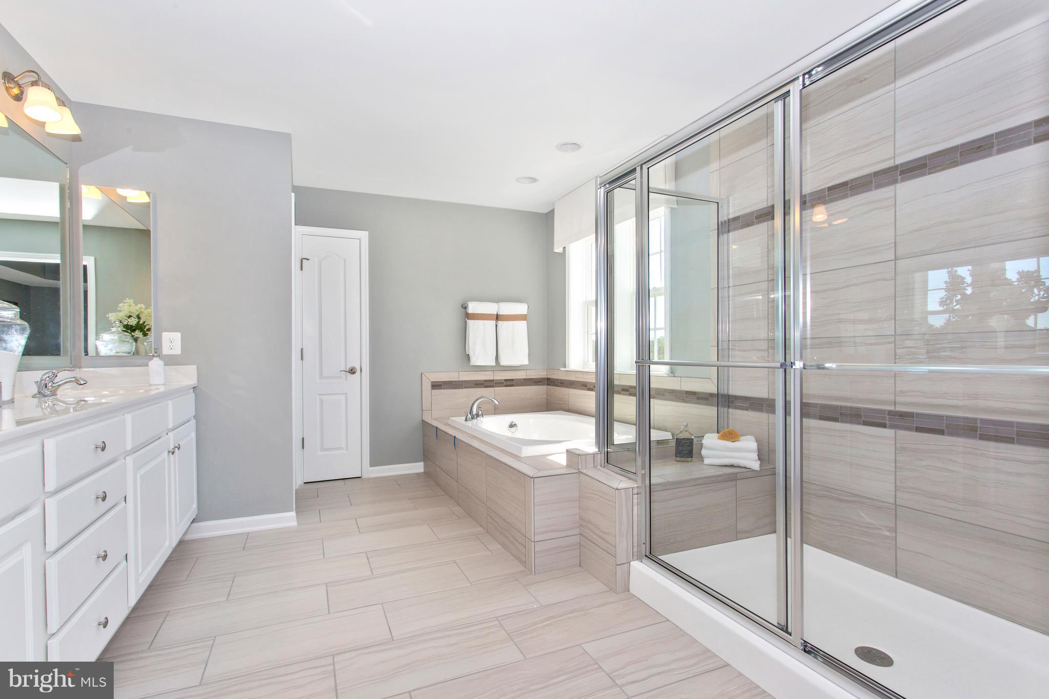 2112 Gable Drive Jessup, MD 20794 - Photo 20 of 27 a spacious bathroom with a granite countertop tub shower and mirror