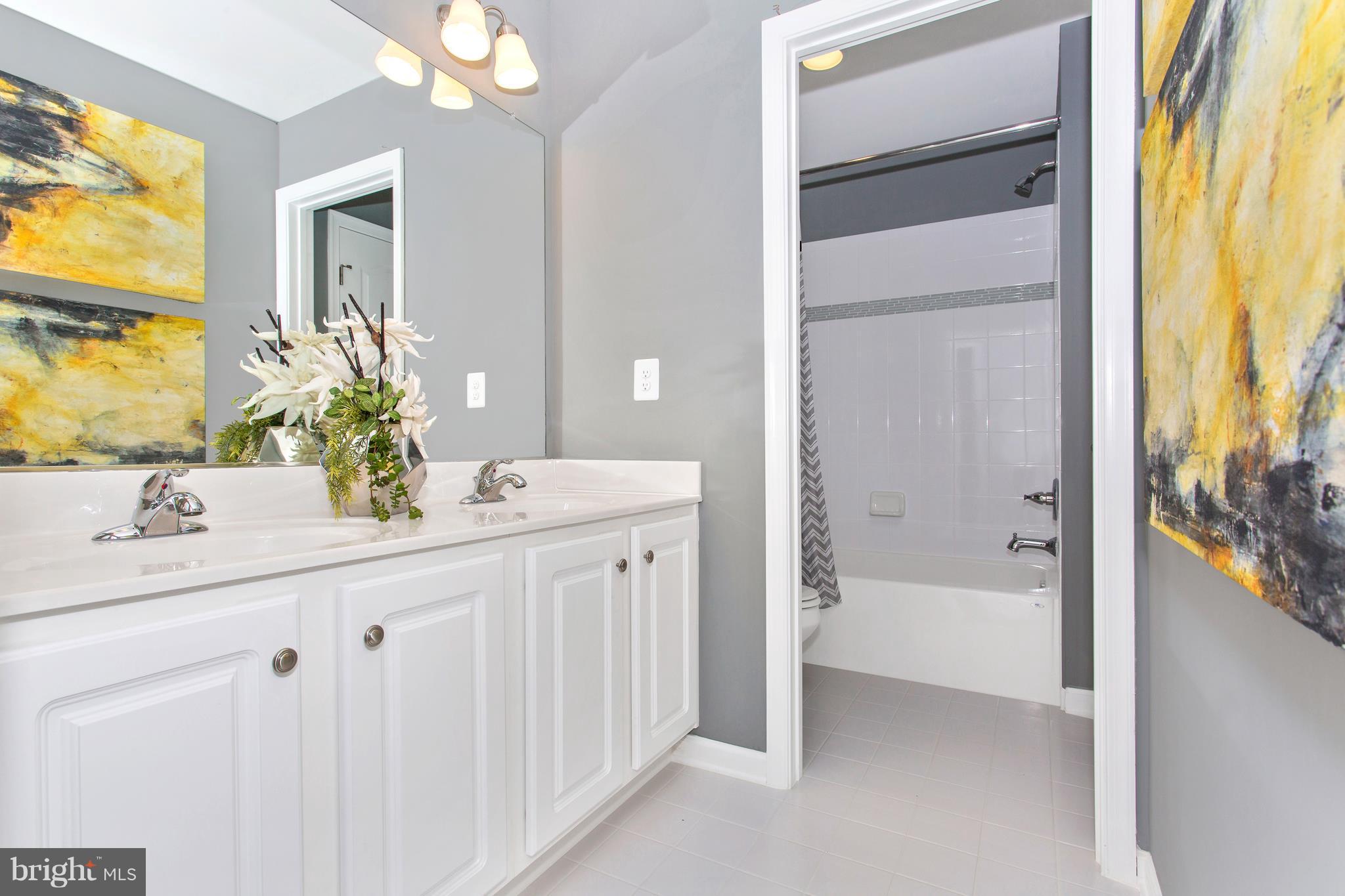 2112 Gable Drive Jessup, MD 20794 - Photo 3 of 27 a bathroom with a double vanity sink and a mirror